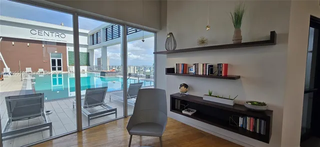 a room with furniture a rug and a window