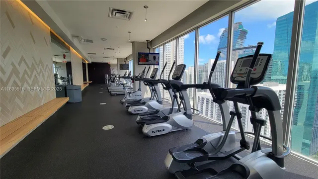 a room with lots of chairs and mirrors