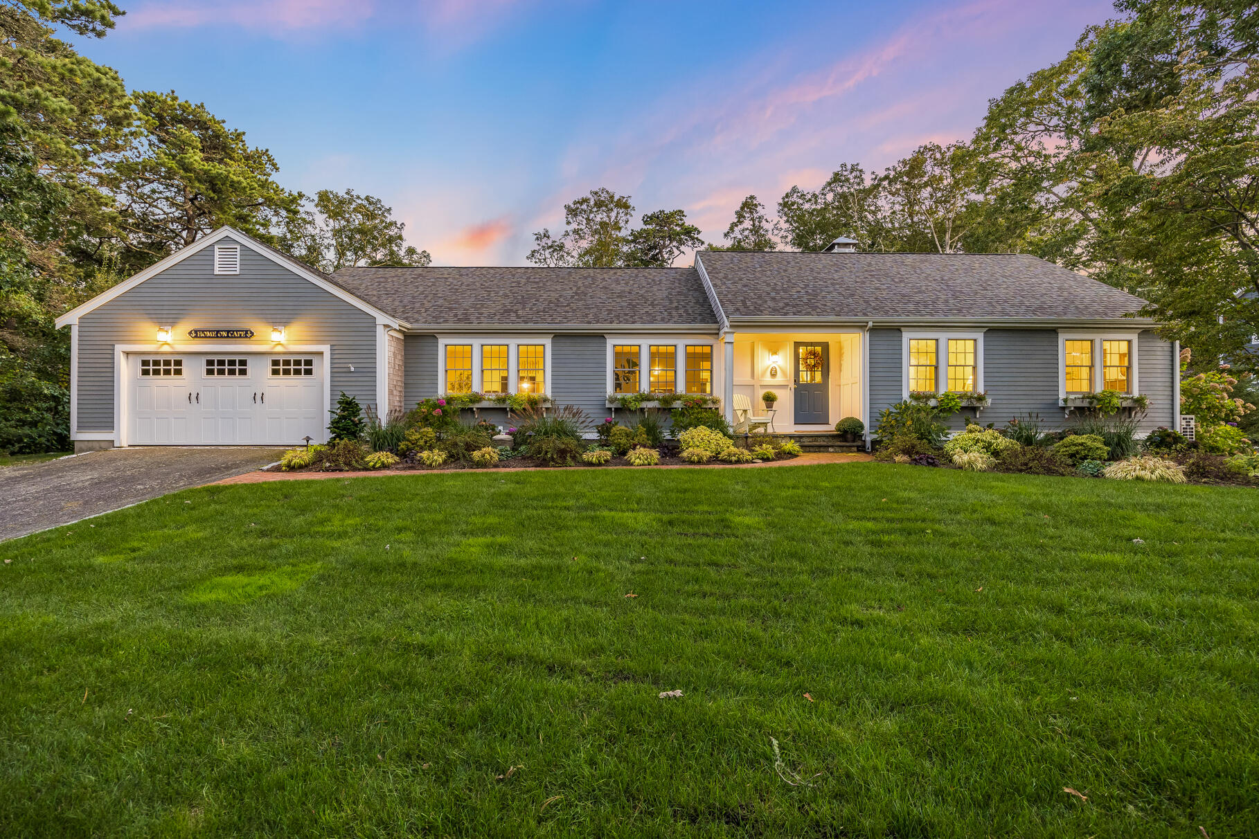 a front view of a house with a garden