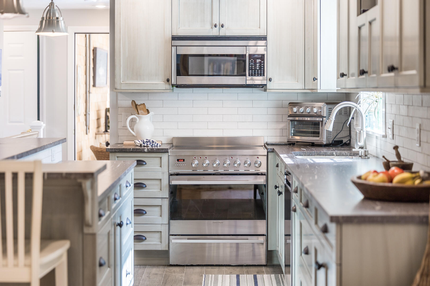 51 North Gate Road Chatham, MA 02633 - Photo 18 of 50 a kitchen with stainless steel appliances granite countertop a stove and a white cabinets