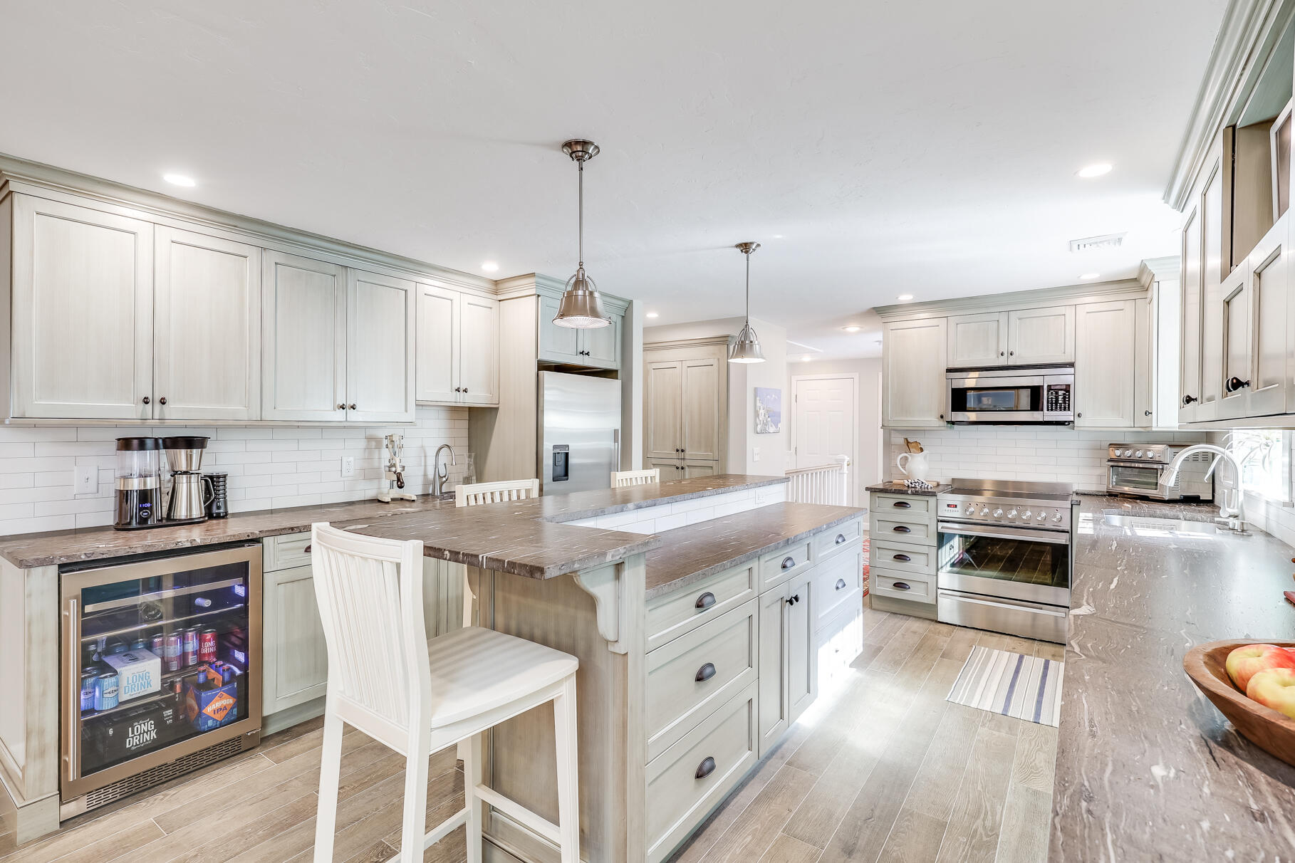 51 North Gate Road Chatham, MA 02633 - Photo 6 of 50 a kitchen with stainless steel appliances granite countertop a stove top oven a sink dishwasher and white cabinets with wooden floor