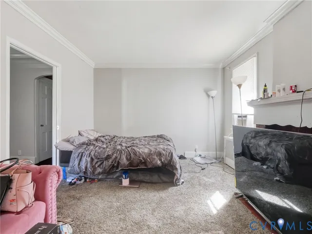 a bedroom with a bed and a couch