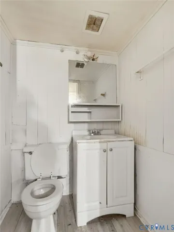 a bathroom with a granite countertop toilet sink and mirror