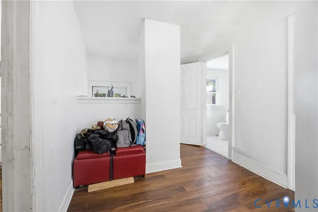 a view of a room with wooden floor and a window