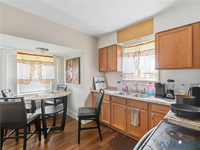 a kitchen with a table chairs sink and cabinets