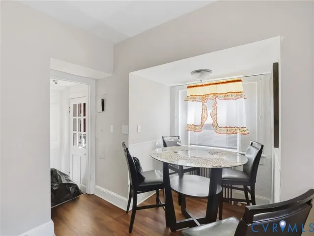 a dining room with furniture and wooden floor