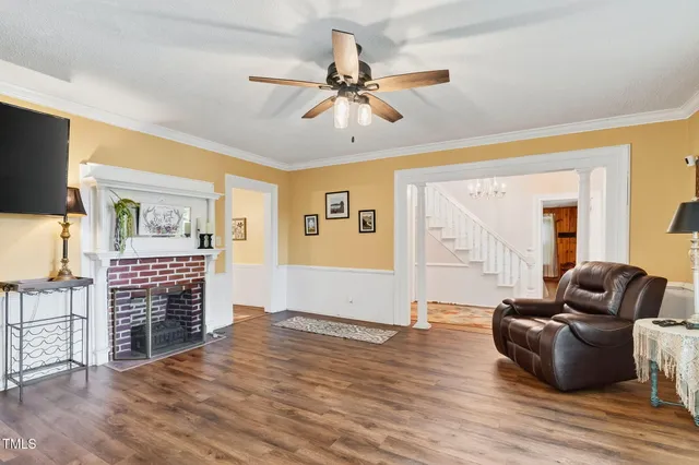 a living room with furniture and a wooden floor
