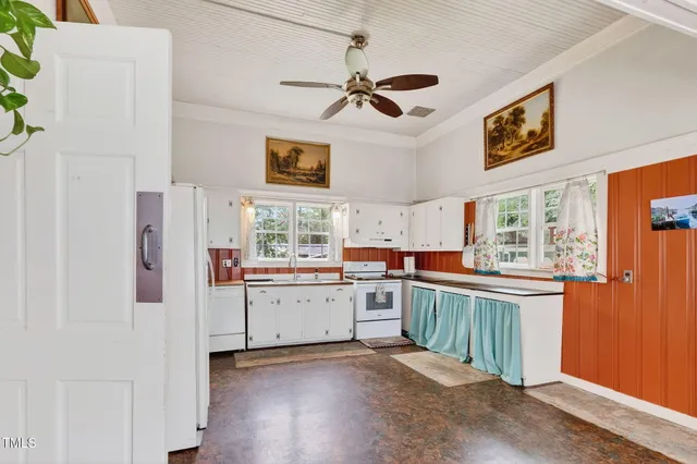 a kitchen with cabinets and wooden floor