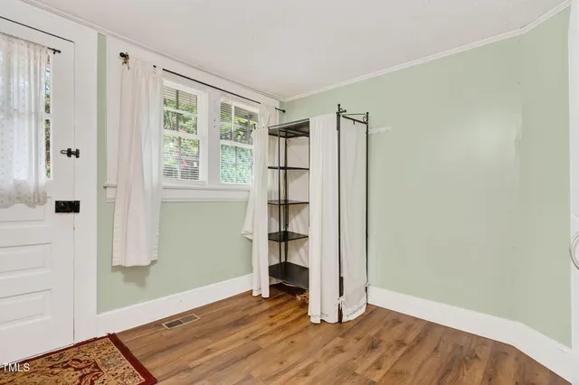 a bedroom with furniture and a rug