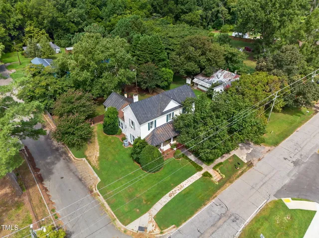 an aerial view of a house with a yard