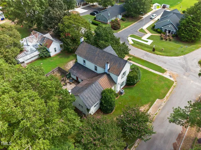 an aerial view of a house with outdoor space