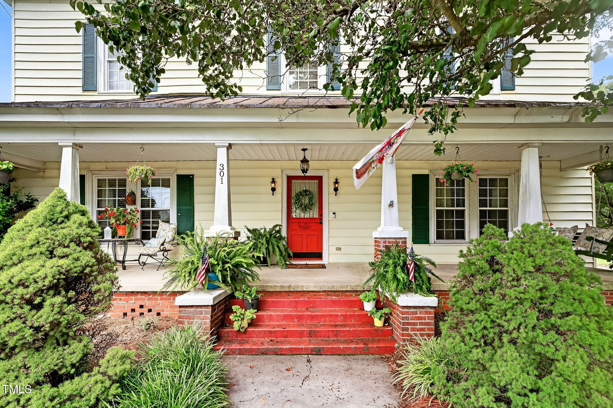 301 2nd Street Spring Hope, NC 27882 - Photo 5 of 49 front view of a house with potted plants and a bench