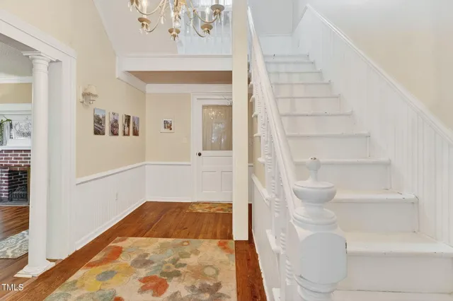 a view of an entryway with wooden floor and a livingroom view