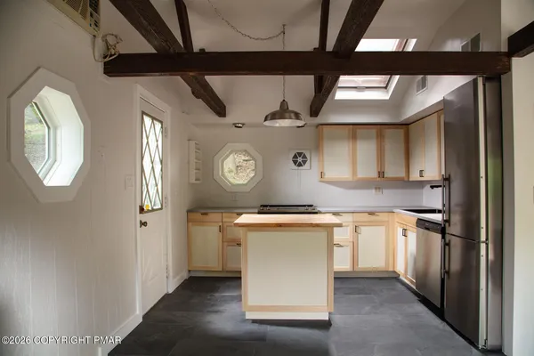 a kitchen with stainless steel appliances granite countertop a sink and cabinets