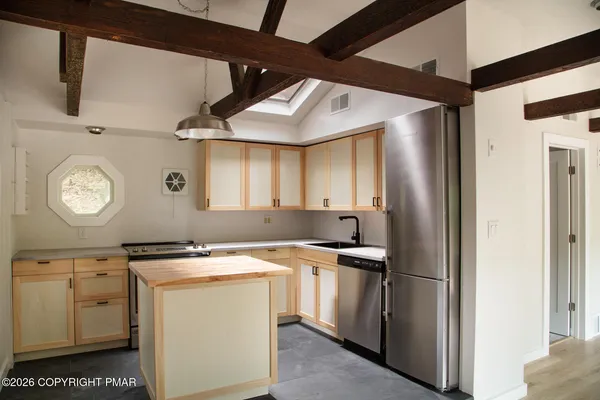 a kitchen with a sink cabinets and stainless steel appliances