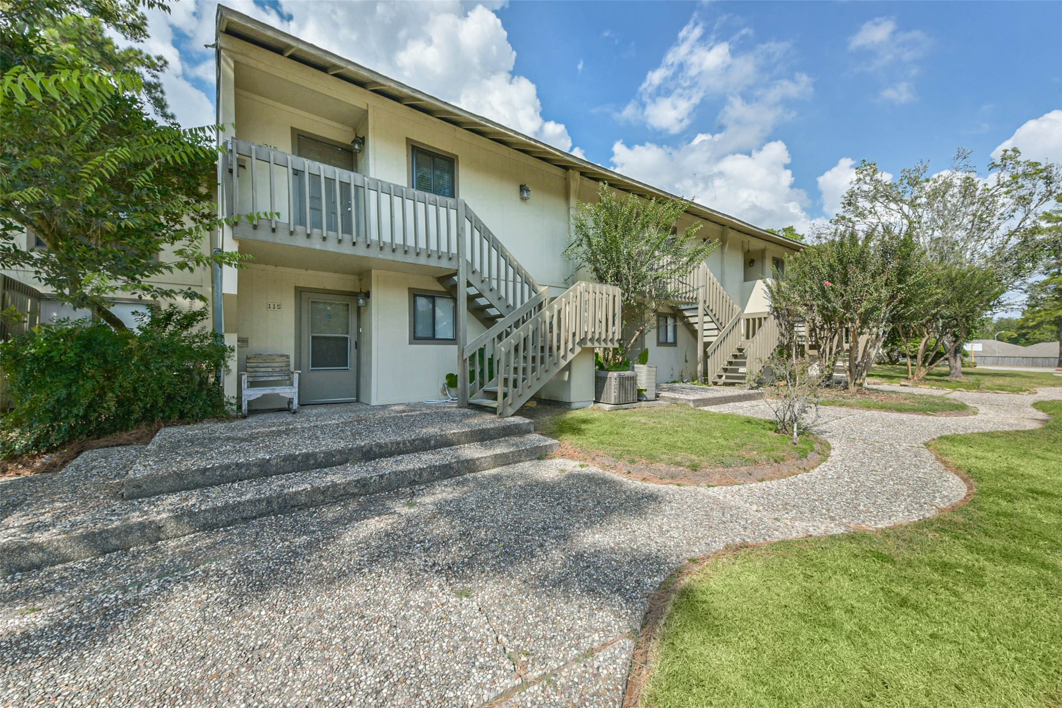 15919 Golf Club Drive, Unit 215 Crosby, TX 77532 - Photo 12 of 16 a view of a white house with a yard