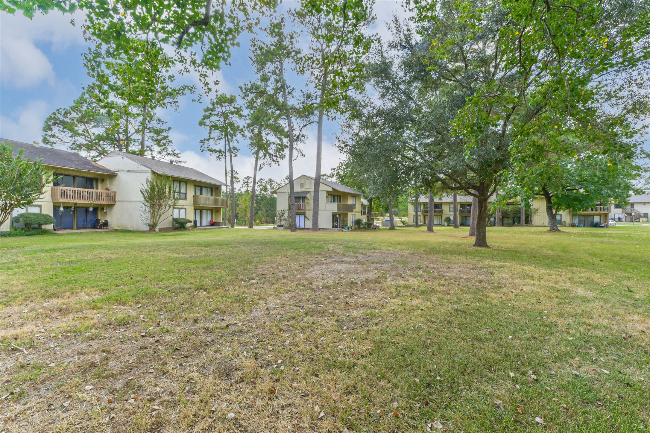 15919 Golf Club Drive, Unit 215 Crosby, TX 77532 - Photo 14 of 16 a house with huge green field
