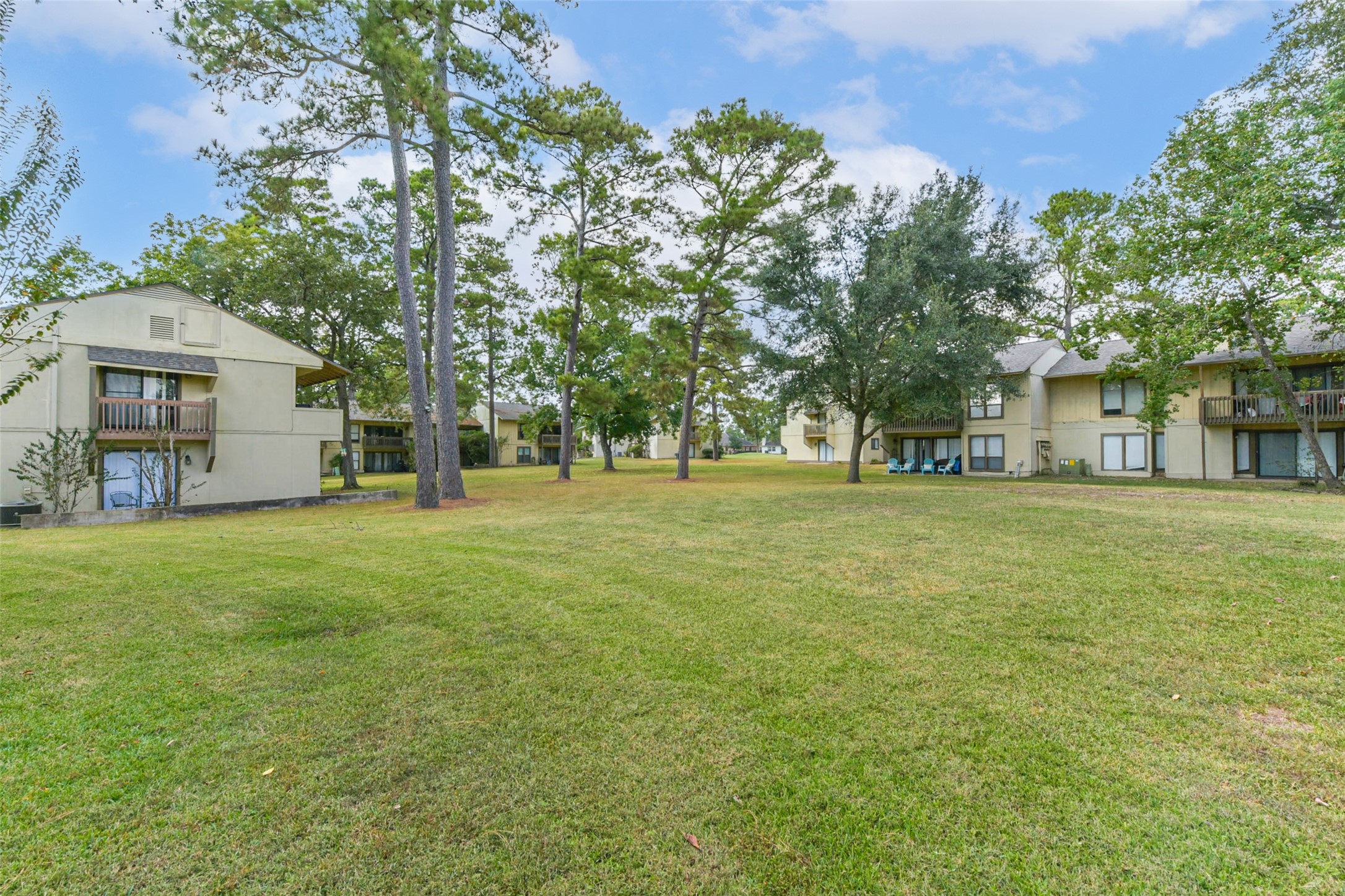 15919 Golf Club Drive, Unit 215 Crosby, TX 77532 - Photo 15 of 16 a view of a house with a big yard