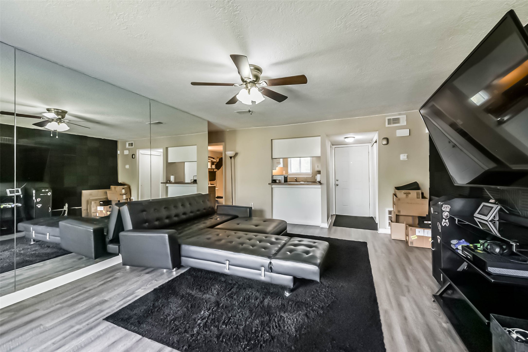 15919 Golf Club Drive, Unit 215 Crosby, TX 77532 - Photo 2 of 16 a living room with furniture and a flat screen tv