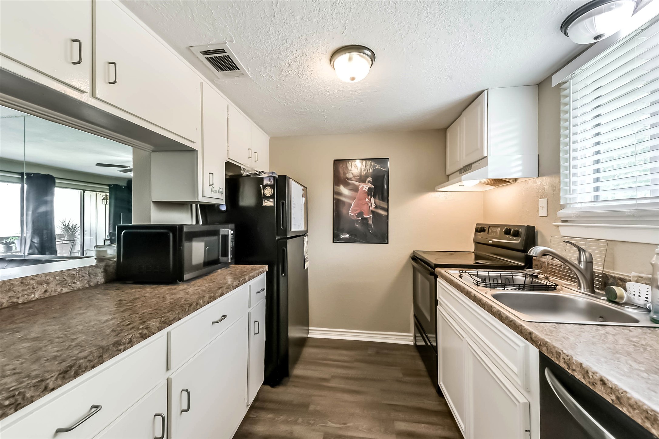 15919 Golf Club Drive, Unit 215 Crosby, TX 77532 - Photo 3 of 16 a kitchen with stainless steel appliances granite countertop a sink stove and refrigerator