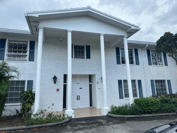 a front view of a house with plants