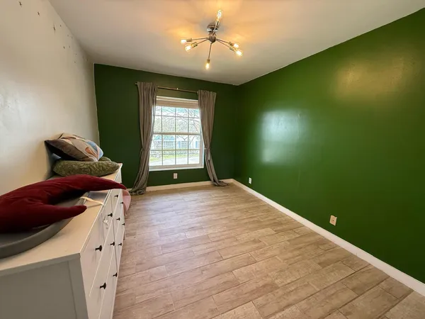 a bedroom with bed and window