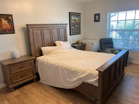 a bedroom with a bed and a flat screen tv