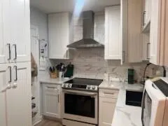 a kitchen with stainless steel appliances granite countertop a stove and a refrigerator