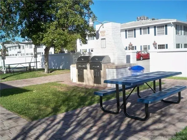 a view of a house with backyard and porch