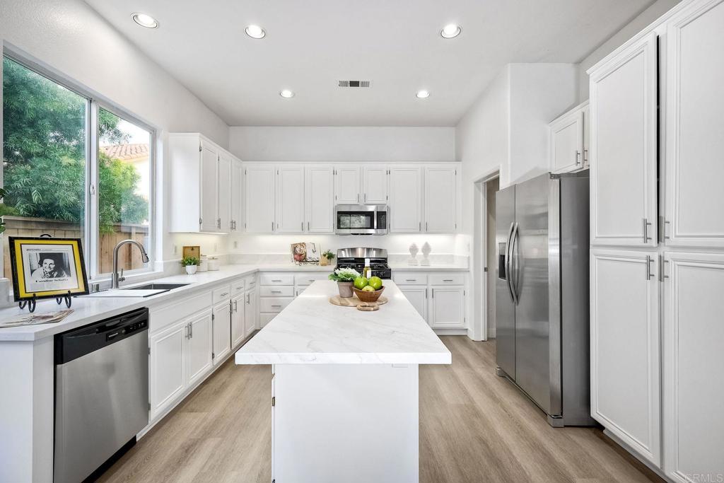 1120 Lassen Peak Place Chula Vista, CA 91913 - Photo 13 of 48 a kitchen with counter top space a sink appliances and cabinets
