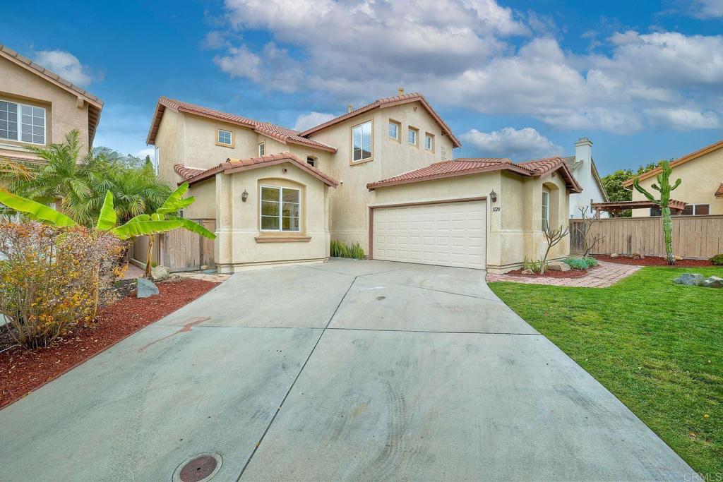 1120 Lassen Peak Place Chula Vista, CA 91913 - Photo 2 of 48 a front view of a house with a yard and garage