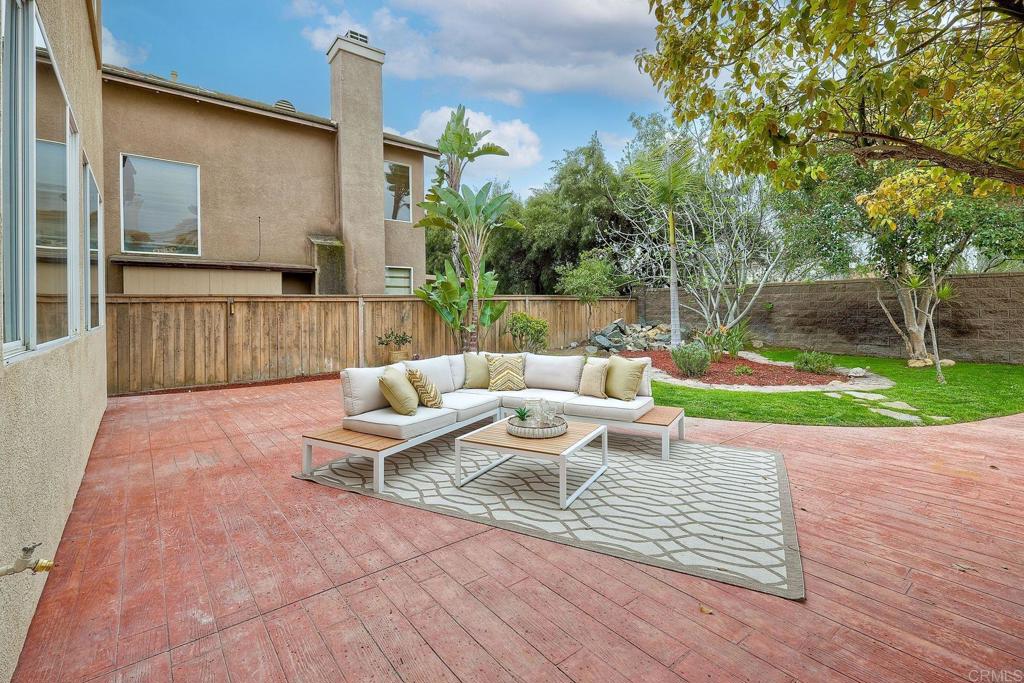 1120 Lassen Peak Place Chula Vista, CA 91913 - Photo 32 of 48 a view of a patio with couches and a table and chairs with wooden fence