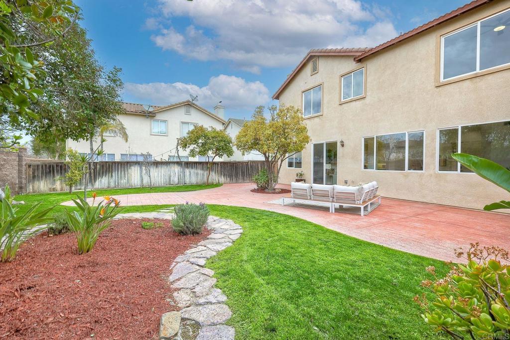 1120 Lassen Peak Place Chula Vista, CA 91913 - Photo 36 of 48 a view of a patio with a table chairs and a swimming pool
