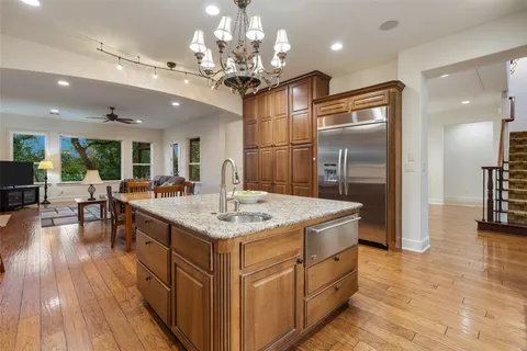a kitchen with a counter space a sink appliances and cabinets