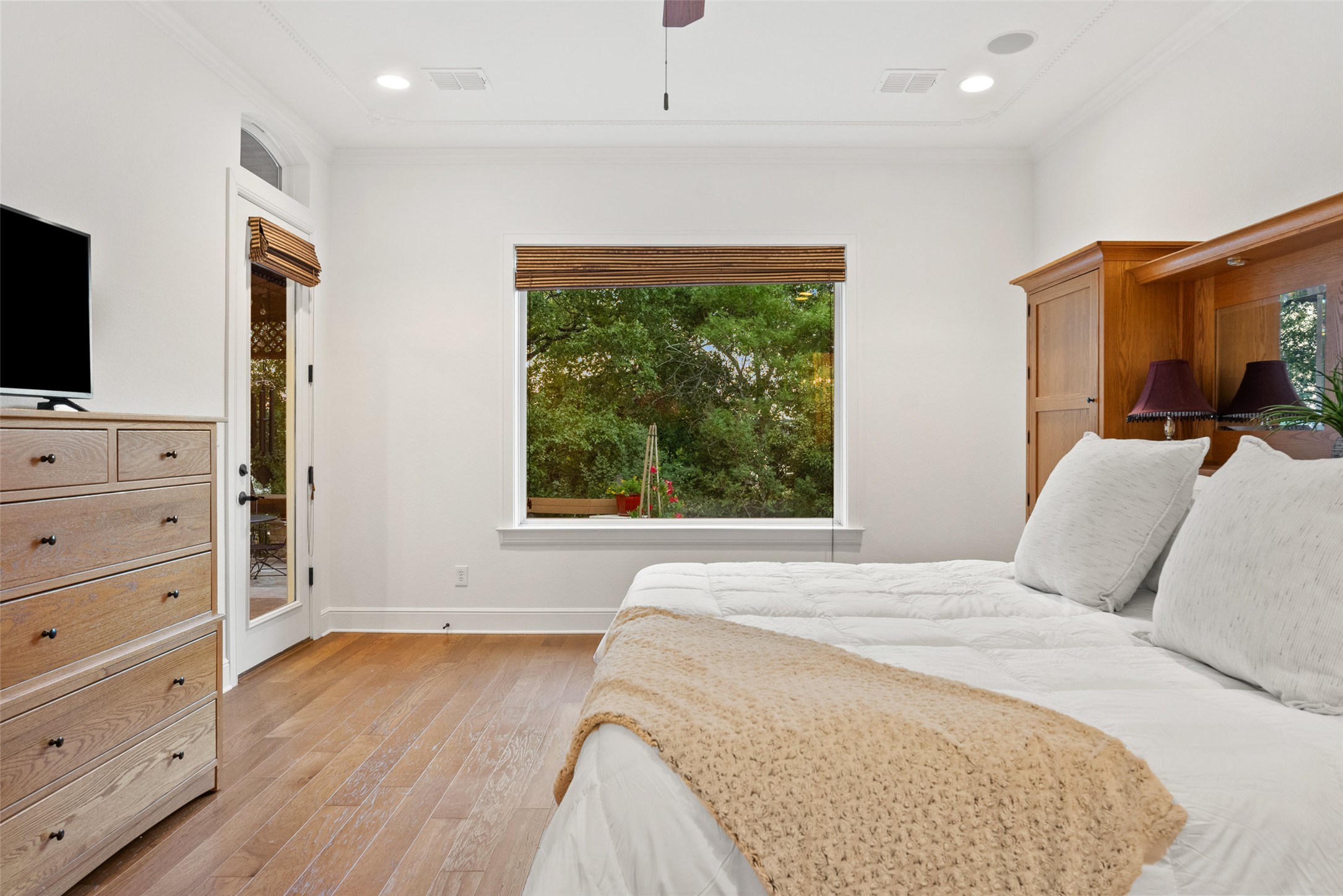 9308 Travertine Cove Austin, TX 78735 - Photo 18 of 40 a bedroom with a bed and a flat screen tv