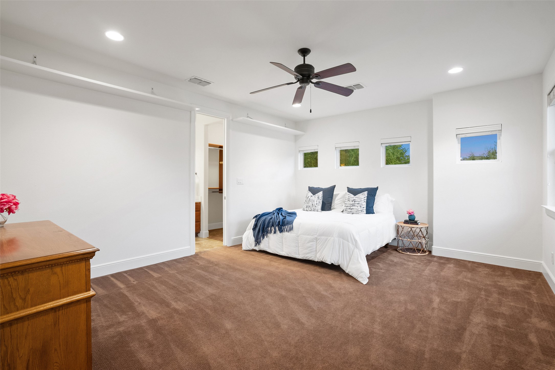 9308 Travertine Cove Austin, TX 78735 - Photo 22 of 40 a bed room with a bed and a ceiling fan