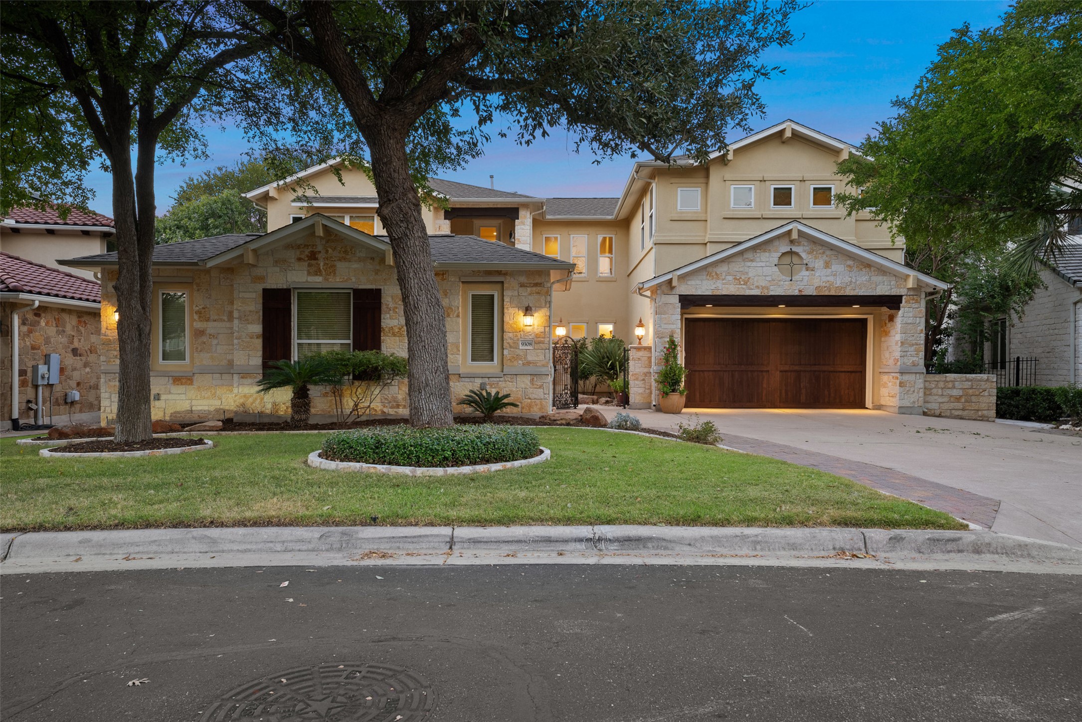 9308 Travertine Cove Austin, TX 78735 - Photo 3 of 40 a front view of a house with a garden and plants