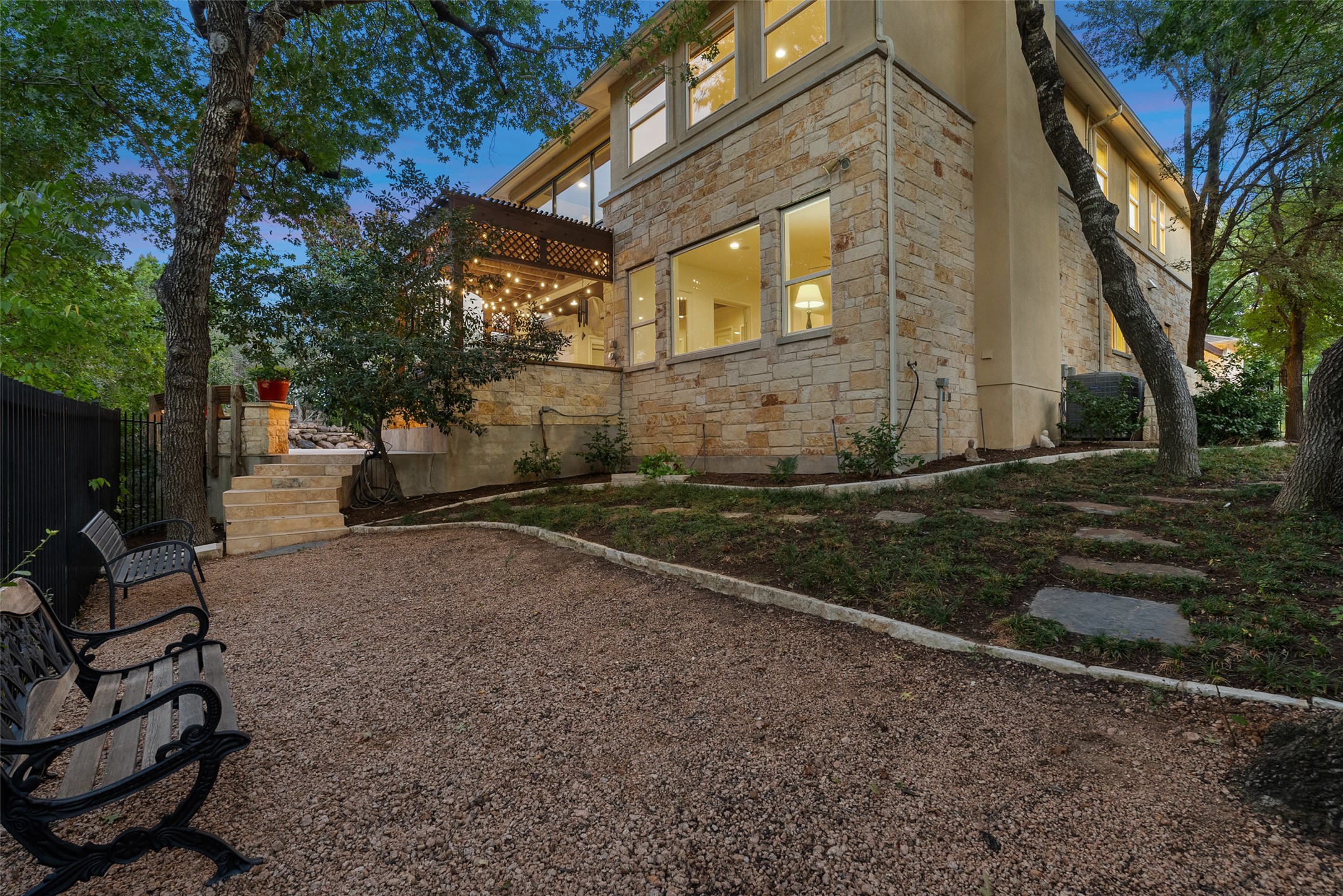 9308 Travertine Cove Austin, TX 78735 - Photo 39 of 40 a view of a brick house with a yard