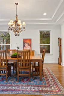 a dining room with furniture a rug and a chandelier