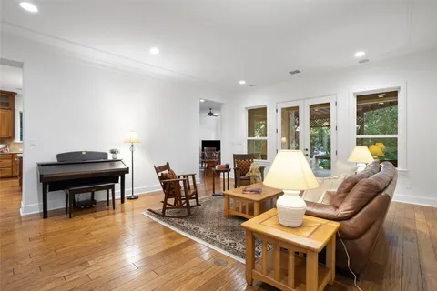 a living room with furniture and wooden floor