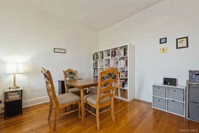 a dining room with furniture and wooden floor