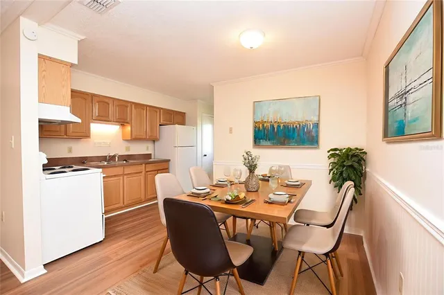 a kitchen with a refrigerator and white cabinets