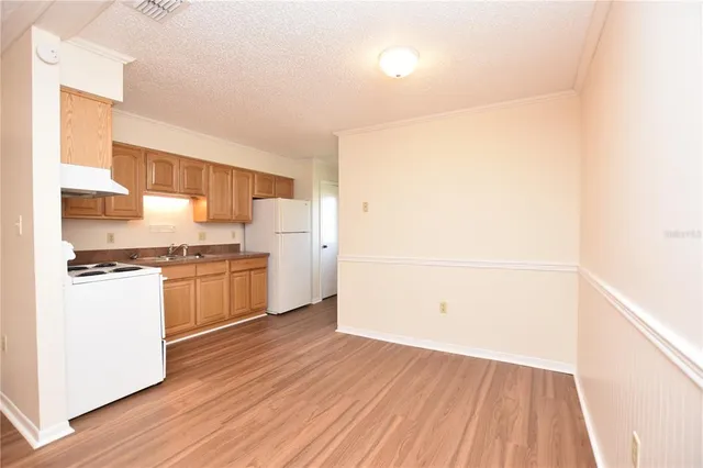 a kitchen with a refrigerator a stove top oven a sink and dishwasher