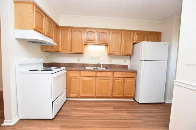 a view of walk in closet with wooden floor