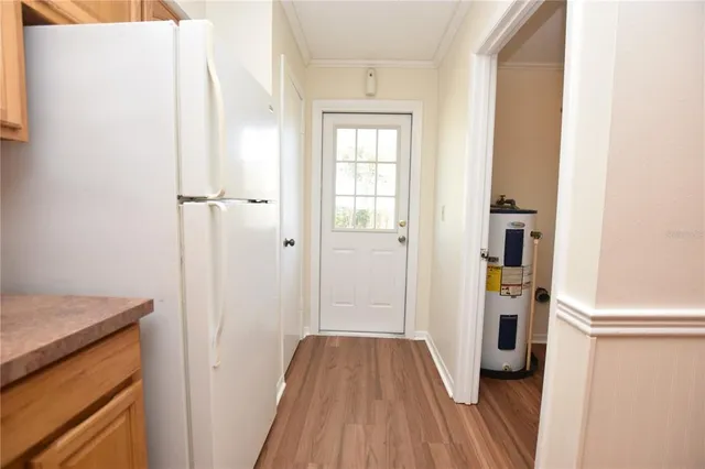 a kitchen with granite countertop white cabinets and white appliances
