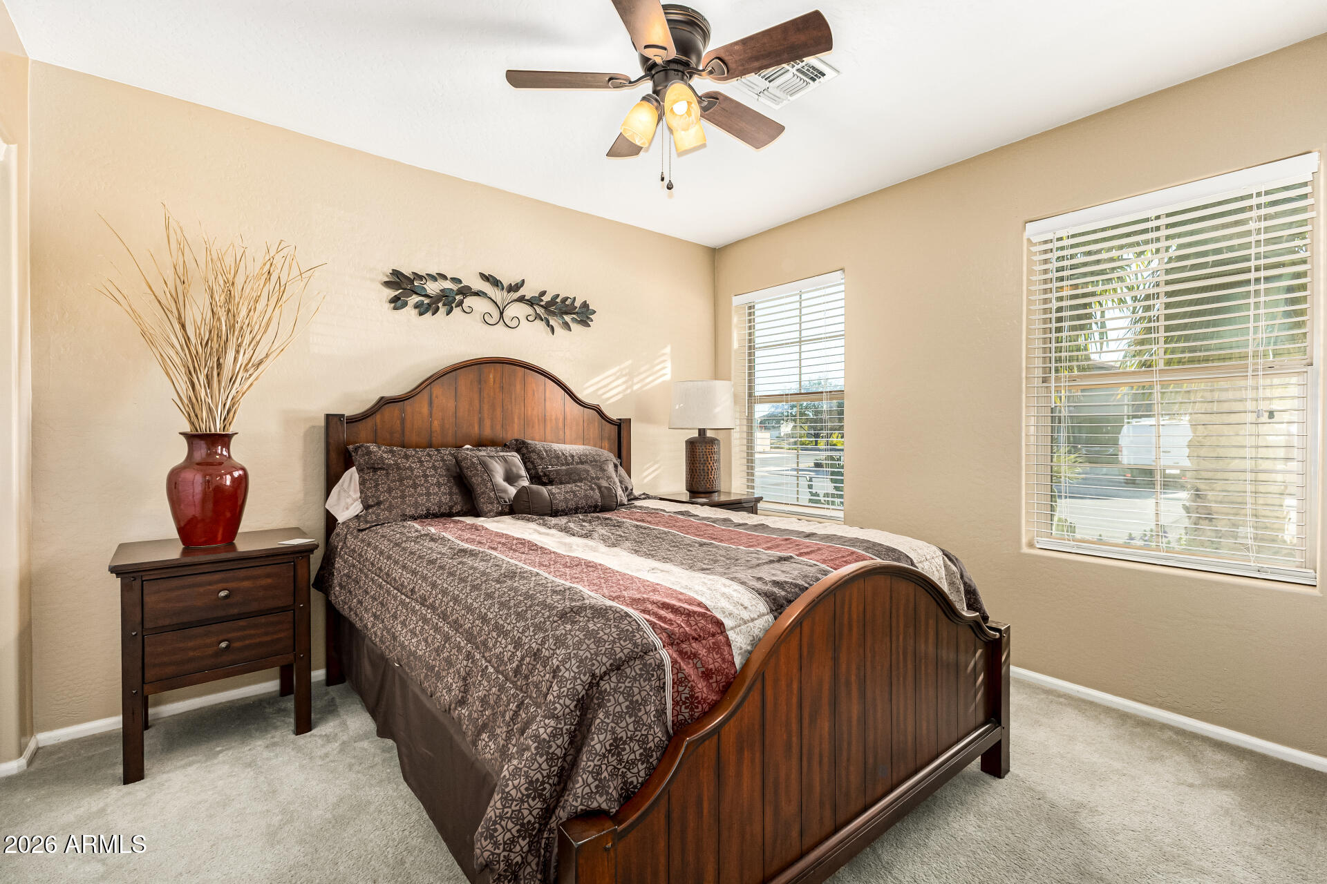 45144 West Desert Garden Road Maricopa, AZ 85139 - Photo 15 of 52 a bedroom with a bed and a chandelier