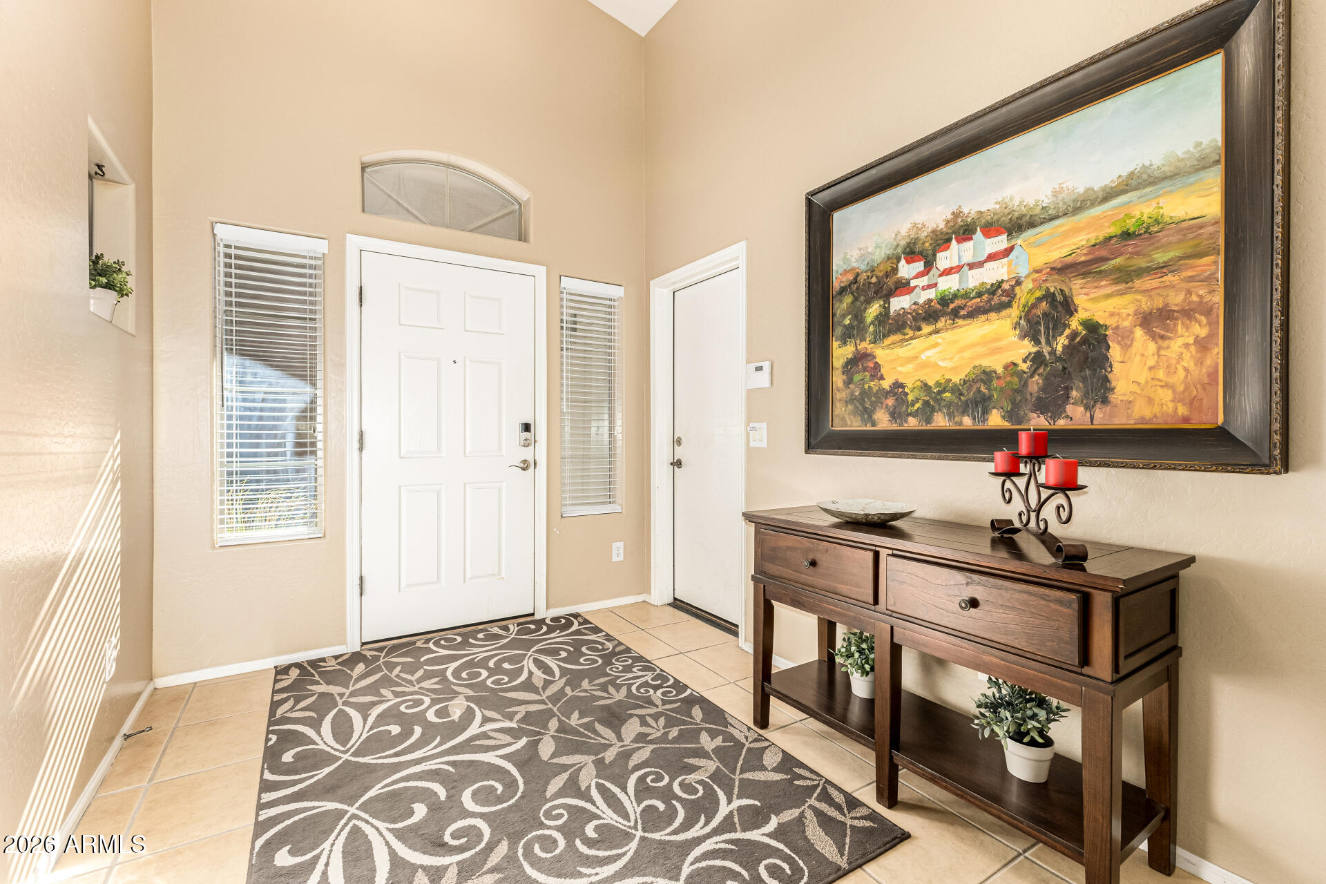 45144 West Desert Garden Road Maricopa, AZ 85139 - Photo 2 of 52 a view of a livingroom with wooden floor and a flat screen tv