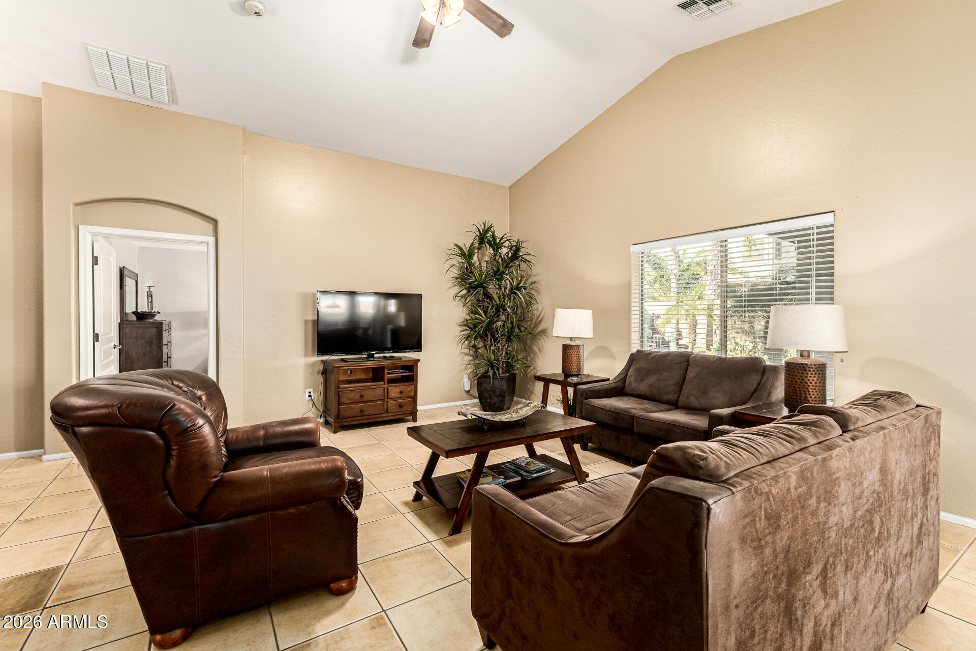45144 West Desert Garden Road Maricopa, AZ 85139 - Photo 21 of 52 a living room with furniture and a flat screen tv