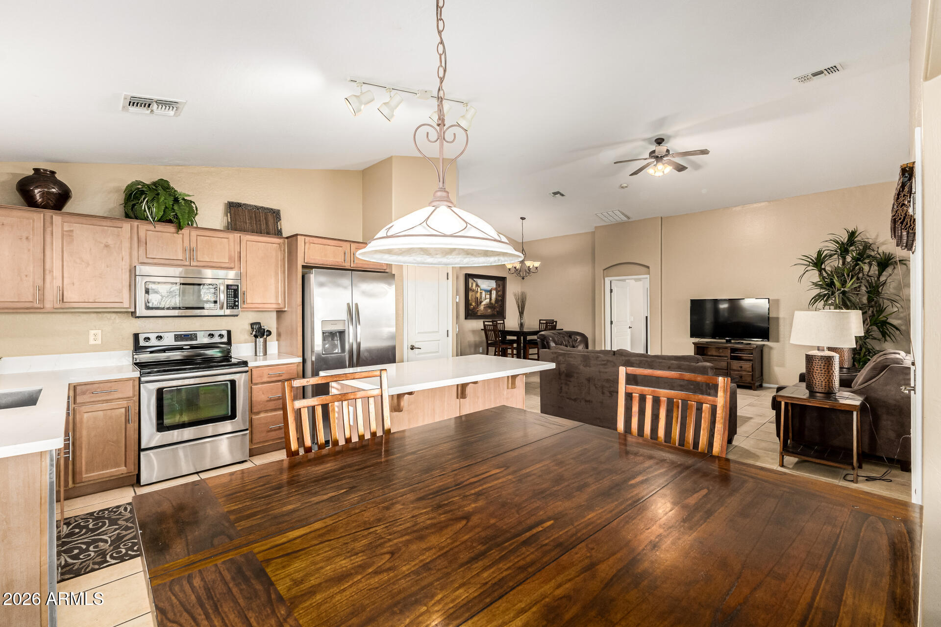 45144 West Desert Garden Road Maricopa, AZ 85139 - Photo 22 of 52 a large kitchen with cabinets wooden floor and stainless steel appliances