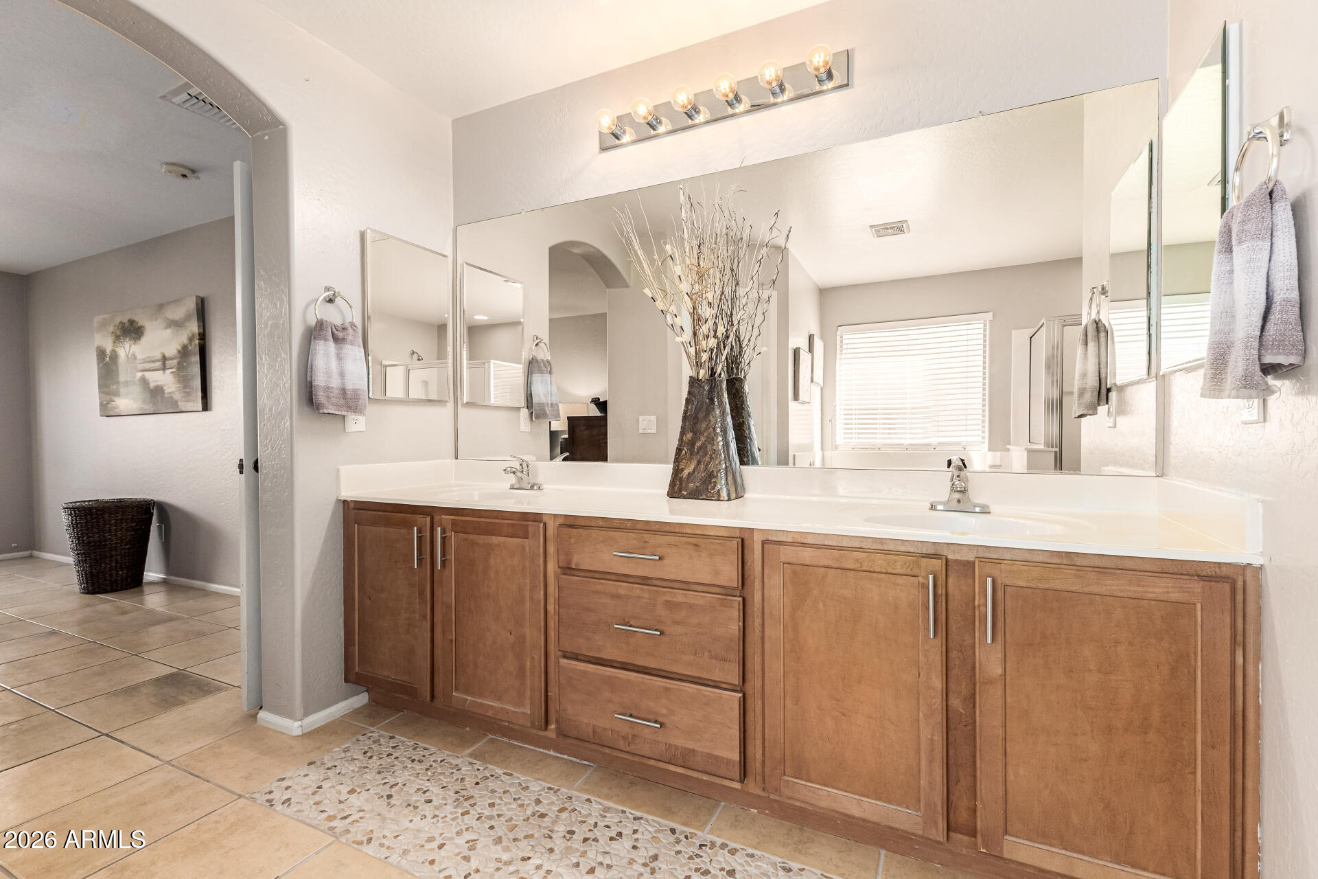 45144 West Desert Garden Road Maricopa, AZ 85139 - Photo 28 of 52 a spacious bathroom with a double vanity sink and a mirror